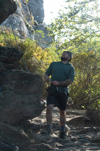 Dusty Roberts studying a rock face. Dusty Roberts studying a rock face and gearing up to climb it.