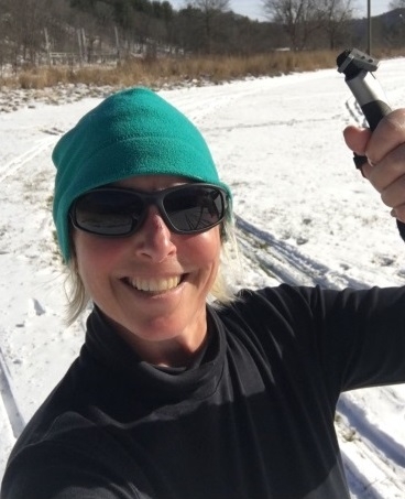 Sarah Miller smiling on skis.